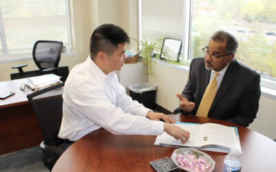 U.S. Small Business District Director Antonio Doss meets with Person of the Year Dr. Zhensen Huang